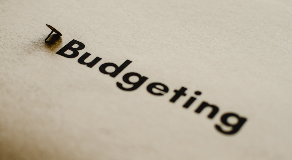 The word budgeting written on a piece of paper